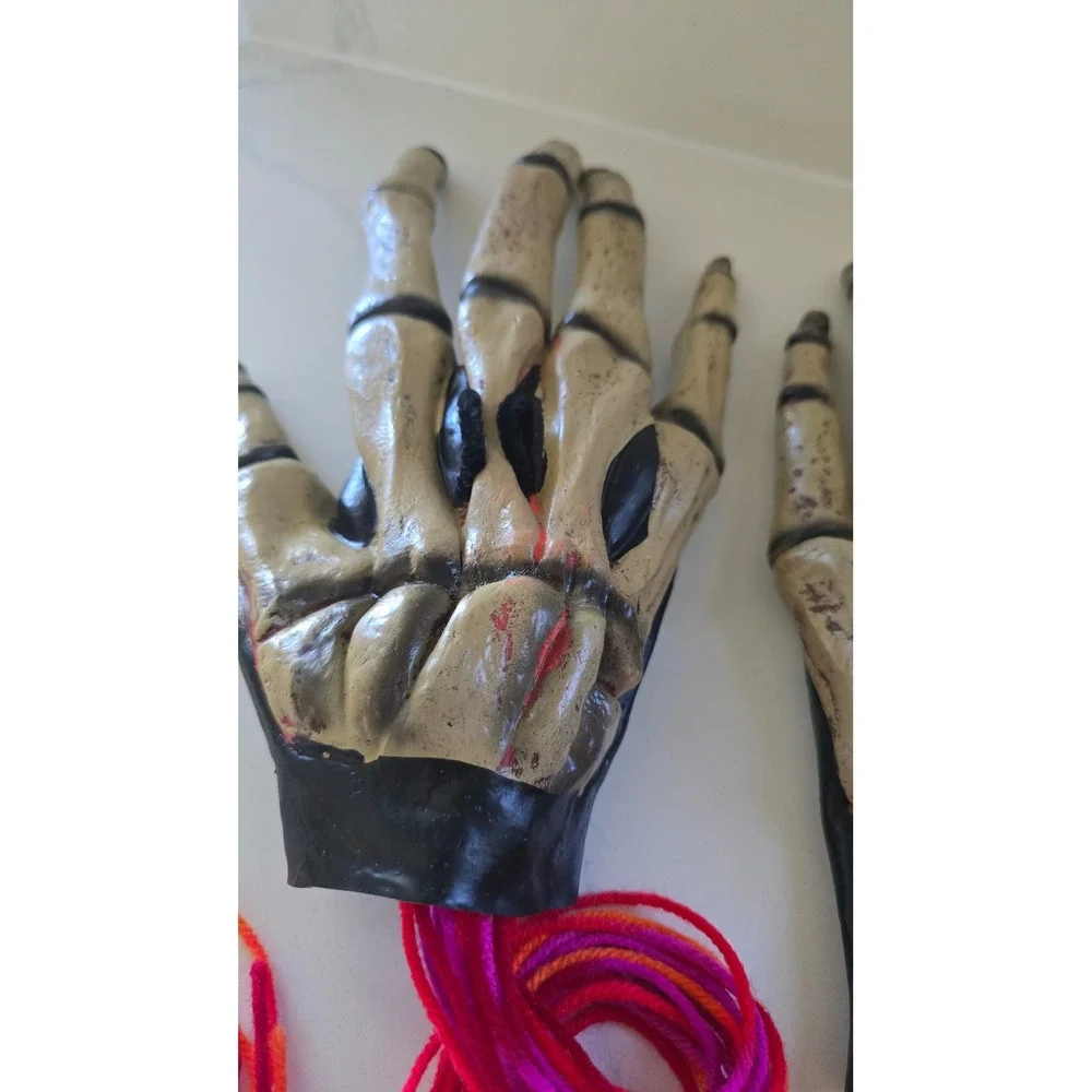 Skeleton Hand Prop Pair Realistic Bone Finish with Yarn Fringe Halloween Decor